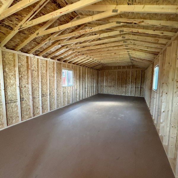 Interior of a Premier gabled cabin showing roof trusses and 2x4 framing
