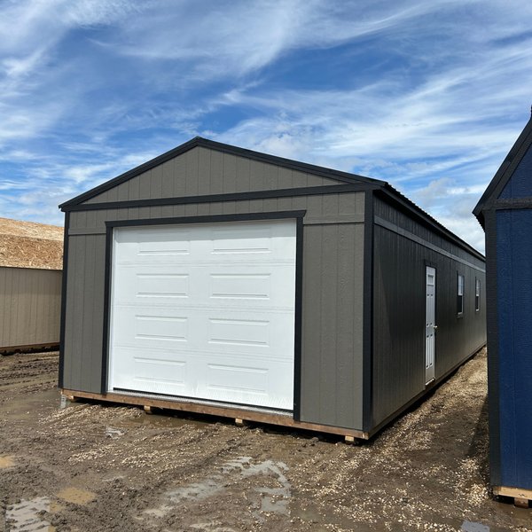 Grey Premier gabled portable garage with white overhead door in Alberta