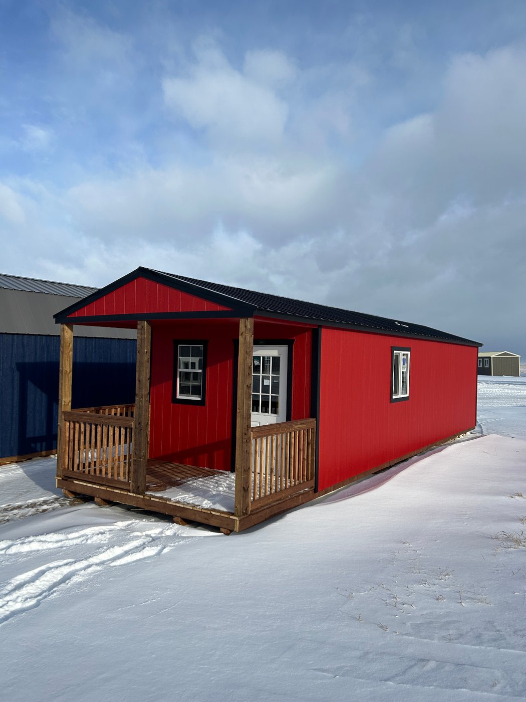 Premier red gabled portable cabin with black metal roof, side profile delivered to Alberta acreage