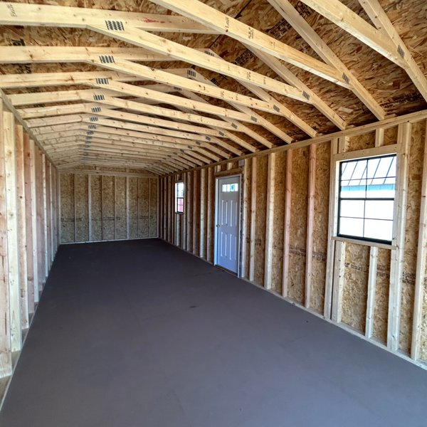 Interior of a Premier portable garage with 2x4 framing, windows and entry door